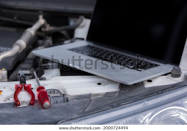 Using a laptop\
computer to check a car engine\
.
