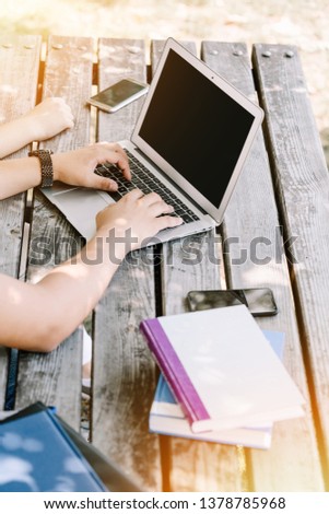 Using laptop and graphical tablet outside. Close up