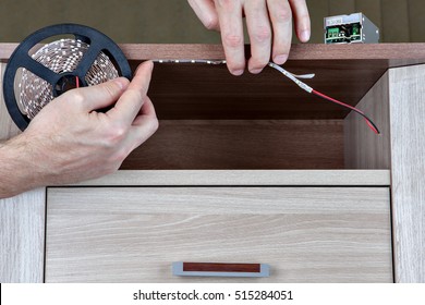 Using LED Strip Light Lighting For Indoor Furniture, Close-up Human Hands Glued Tape On Board.