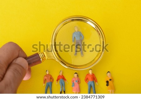 Using a magnifying glass, the staff meticulously combed through the resumes, searching for the perfect fit to hire for the job.
