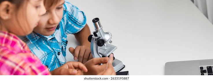 Using microscope. Children plays a scientists in lab by using equipment.