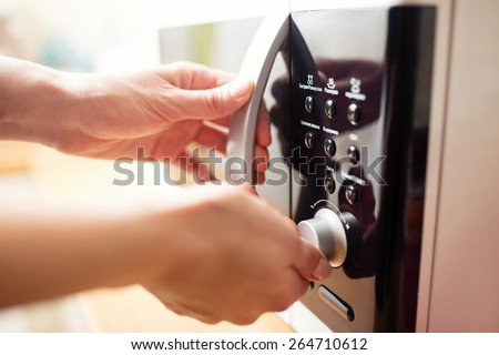 Using microwave oven, close up photo, shallow dof