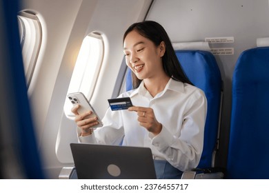Using mobile and credit card, cashless payment, Thoughtful asian people female person onboard, airplane window, perfectly capture the anticipation and excitement of holiday travel. chinese, japanese.