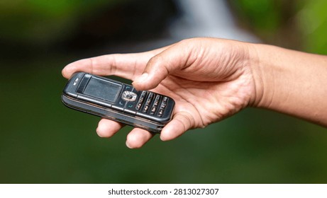 Using a mobile phone in the 2000s. One type of vintage mobile phone.