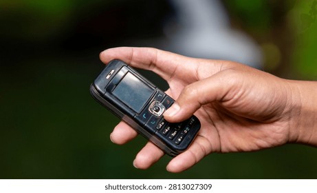 Using a mobile phone in the 2000s. One type of vintage mobile phone.