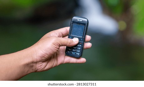 Using a mobile phone in the 2000s. One type of vintage mobile phone.