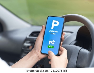 Using mobile phone in application mode search for parking spaces for 1 hour rental in online payment concept traffic