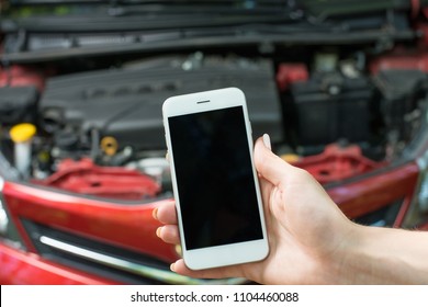 Using A Mobile Phone Call A Car Mechanic Because Car Was Broken.