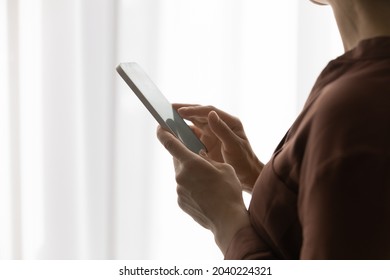 Using online app. Close up of young woman user of modern smartphone gadget. Happy gen z female browse internet on phone type message in dating chat dial number swipe quick menu on screen. Copy space