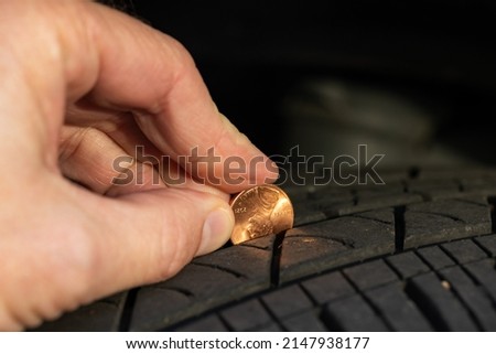 Using a penny to check tread depth on a tire