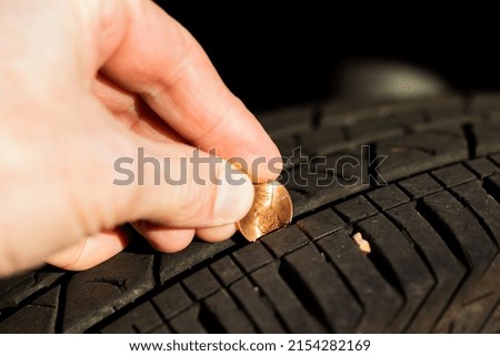 Using a penny to check tread depth on a tire