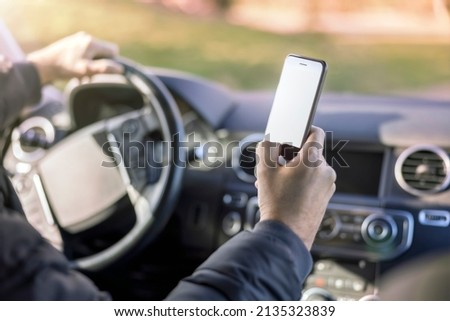 Using a phone in a car texting while driving concept for danger of text message and being distracted