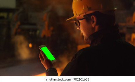 Using a Phone with Green Screen in Foundry. Industrial Environment. Great for Mock-up usage. - Powered by Shutterstock