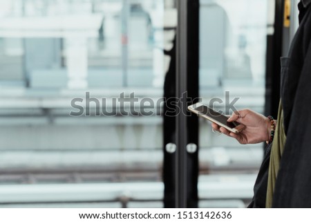 Using phone while wating on something.