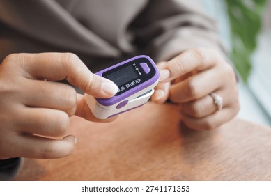 Using a pulse oximeter to check oxygen levels at a cafe