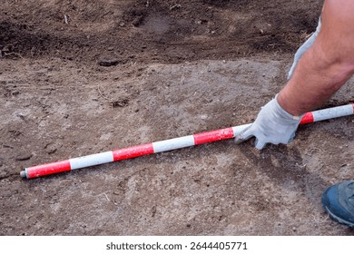 Using a Ranging Rod for Scale in an Archaeological Photograph.