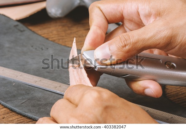 Using the\
retractable utility knife to cut\
leather