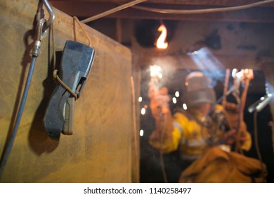 Using Safety Gas Testing Detector Atmosphere While Blurry Pic Of Rope Access Welder Wearing Fully Safety Uniform Fall Protection Helmet, Welding Glove Harness, Commencing Welding, In Confined Space 