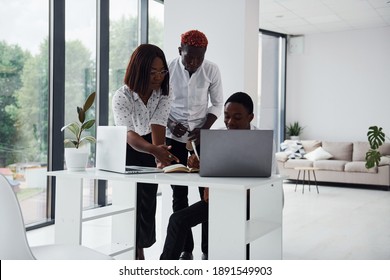 Using Same Laptop For The Project. Group Of African American Business People Working In Office Together.