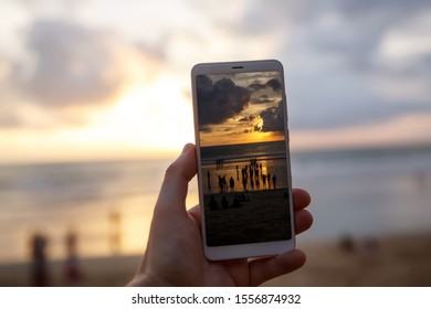 Using a Samrtphone. Photographing sunset on a mobile phone