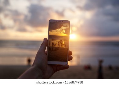 Using a Samrtphone. Photographing sunset on a mobile phone