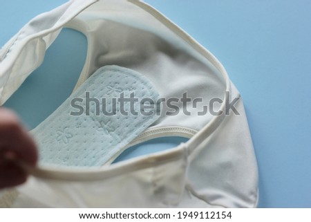 Using Sanitary pads with white women underwear panties in blue background. 