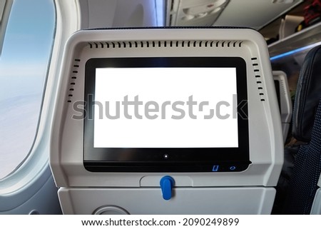 Using the seatback screen on a plane trip, watching movies, displaying flight data. Blank white touchscreen
