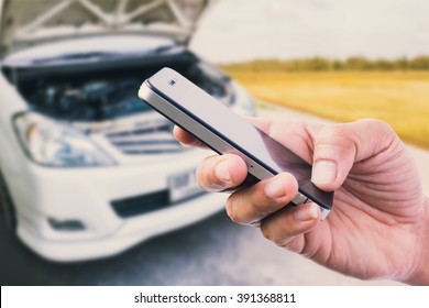 Using Smart Phone With Broken Car Background
