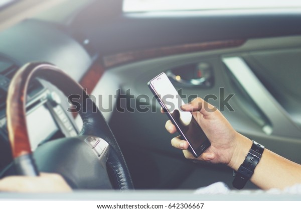 using  smart phone\
mobile phone in car.