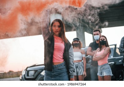 Using smoke. Group of protesting young people that standing together. Activist for human rights or against government.