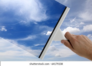 Using a squeegee to clear the blue sky above