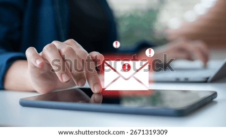 using a tablet with an email security alert icon. Phishing mail, spam warning, cybersecurity threat, online fraud, data protection, and digital safety concept for business communication.