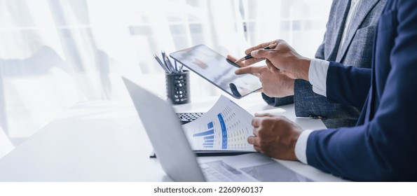 Using tablet pc, Consultant between bookkeepers and accounting lawyer consultation about asset, balance sheet, stock market statistics and yearly tax law, protect business from bribery. - Shutterstock ID 2260960137