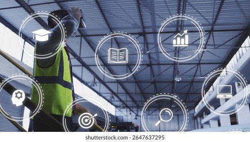 Using tablet worker wearing safety vest by railing monitoring data icons in warehouse, copy space. Industrial, technology, analytics, logistics, construction, modern, teamwork