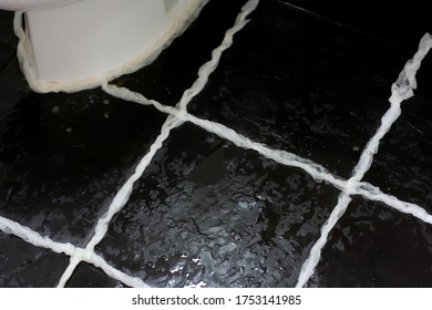 Using Tissue Paper And Toilet Cleaner To Clean Tile Grout In Bathroom