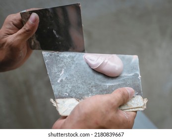 Using Two Trowels To Mix A Batch Of Epoxy Putty.