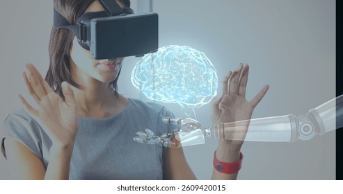 Using virtual reality headset, woman interacting with robotic hand and holographic brain. Technology, innovation, VR, robotics, hologram, futuristic
