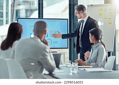 Using visual aid is always a plus. a businessman delivering a presentation in the boardroom.