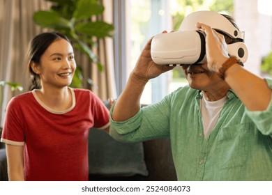 Using VR headset, father exploring virtual reality while daughter smiling nearby. Technology, interaction, innovation, electronic, device, simulation - Powered by Shutterstock