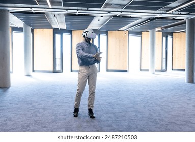 Using VR headset, man exploring virtual environment in modern office space, copy space. Technology, virtual reality, innovation, exploration, digital, immersive