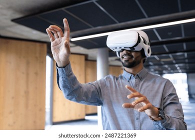 Using VR headset, man interacting with virtual environment in modern office. Technology, virtual reality, futuristic, innovation, interaction, workspace