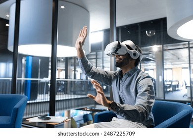 Using VR headset, man interacting with virtual environment in modern office, copy space. Technology, virtual reality, innovation, immersive, digital, interaction - Powered by Shutterstock