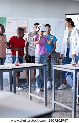 Using VR headset, student engaging in virtual experiment in school classroom. Education, virtual reality, technology, learning, innovation, immersive
