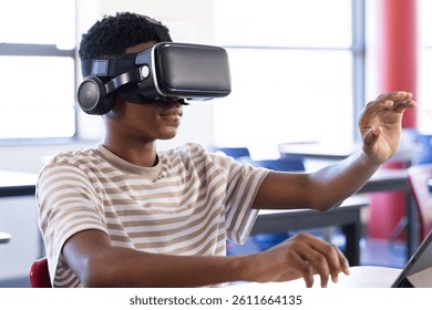 Using VR headset, student exploring virtual reality in school classroom. Technology, education, learning, innovation, digital - Powered by Shutterstock - Get 15% off with code: PIKWIZARD15