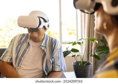 Using VR headsets, family members enjoying virtual reality experience together. Technology, entertainment, gaming, interaction, bonding, innovative - Powered by Shutterstock