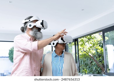 Using VR headsets, senior couple exploring virtual reality experience together. technology, seniors, elderly, innovation, digital, immersive - Powered by Shutterstock