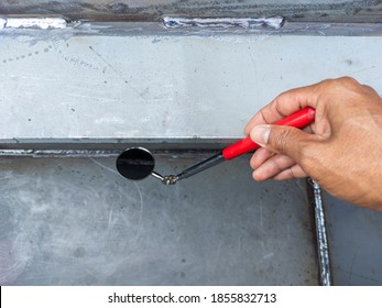 Using welding inspection mirror for check visual welding defects in a niche. - Shutterstock ID 1855832713