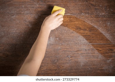 Using Yellow Sponge For Cleaning Dusty Wood