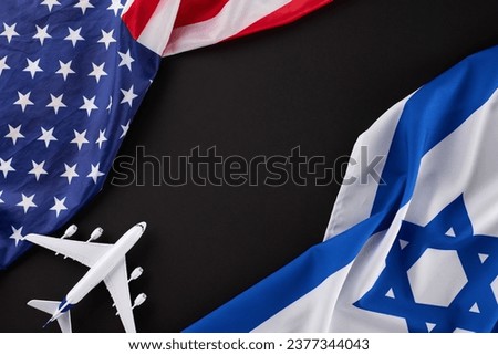 U.S.-Israel aviation linkage troubles. Top view photo of American flag and Israeli flag, airplane on black background with empty space for special message