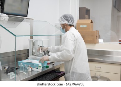 USP 800 Compounding pharmacy during business hours, Experienced compounding pharmacist makes a sterile preparations. Work in a controlled environment. - Powered by Shutterstock